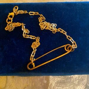 Vintage safety pin necklace reimagined on a gold plated chain.